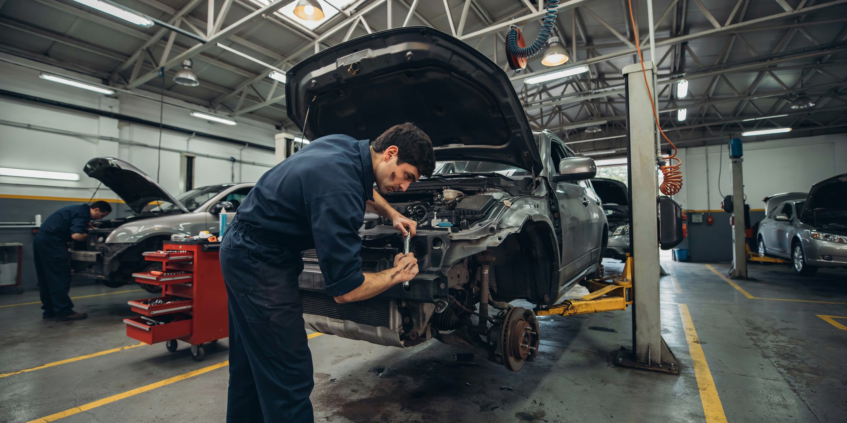 Mechanic working in auto repair shop representing Google Ads marketing for automotive service businesses