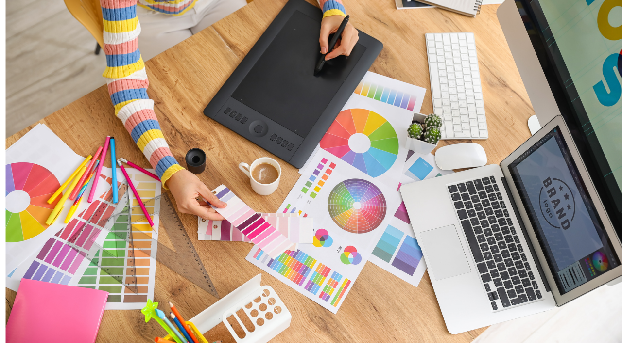 Graphic designer working with color swatches and a laptop