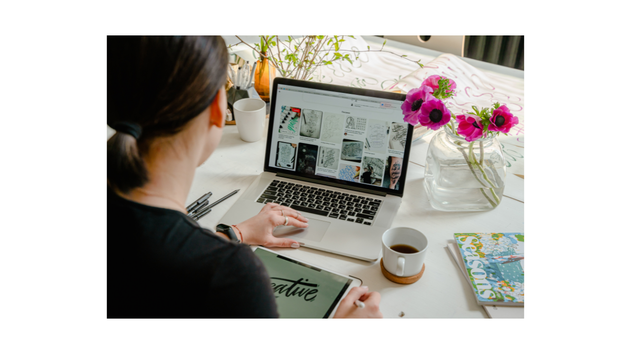 Woman working on website design at a laptop with a mood board
